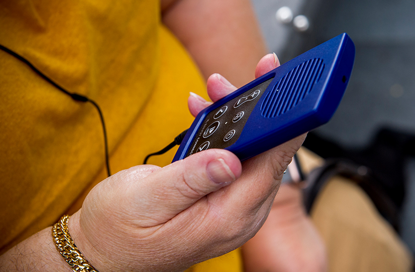 Close up view of person holding an audio playing device