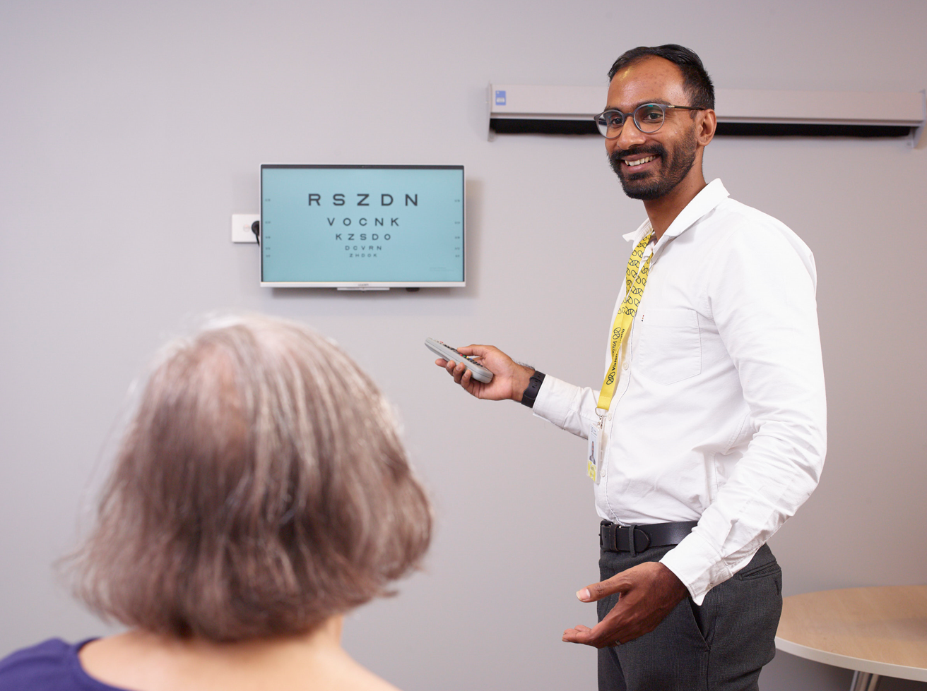 Optometrist Sunil with a patient.