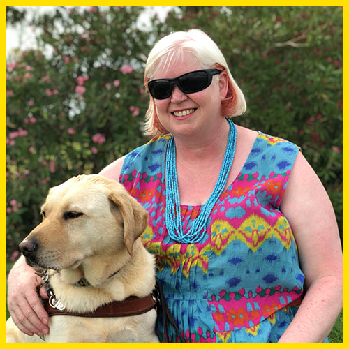 Annette is sitting alongside her dog guide