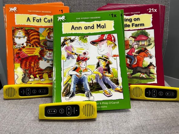 Three of the brightly coloured decodable readers
