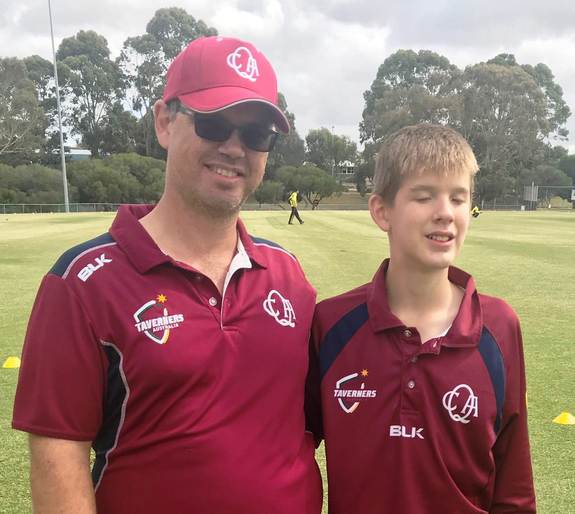 Sean and Dad wearing cricket uniforms