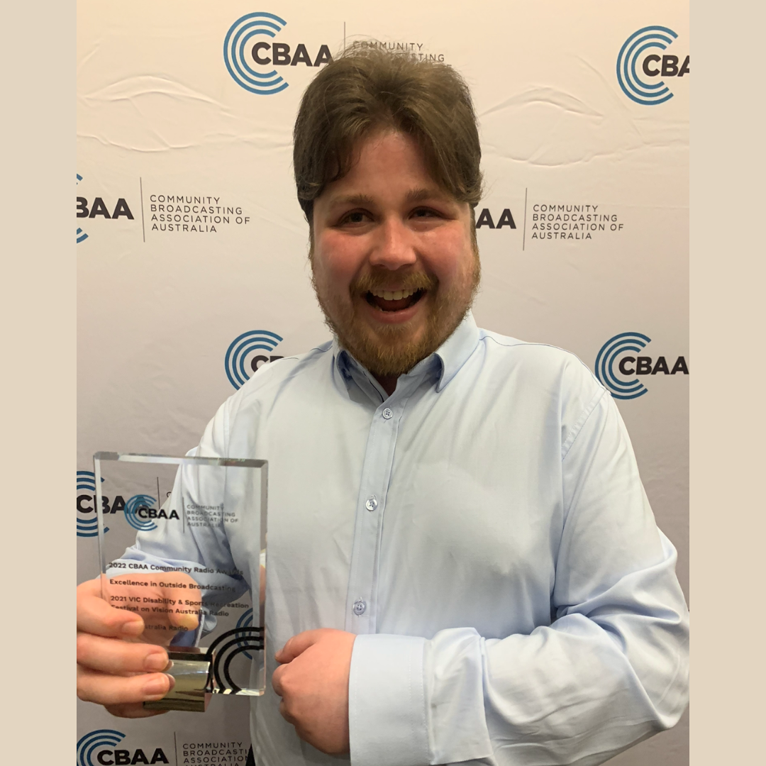 Sam Colley holding his CBAA award.