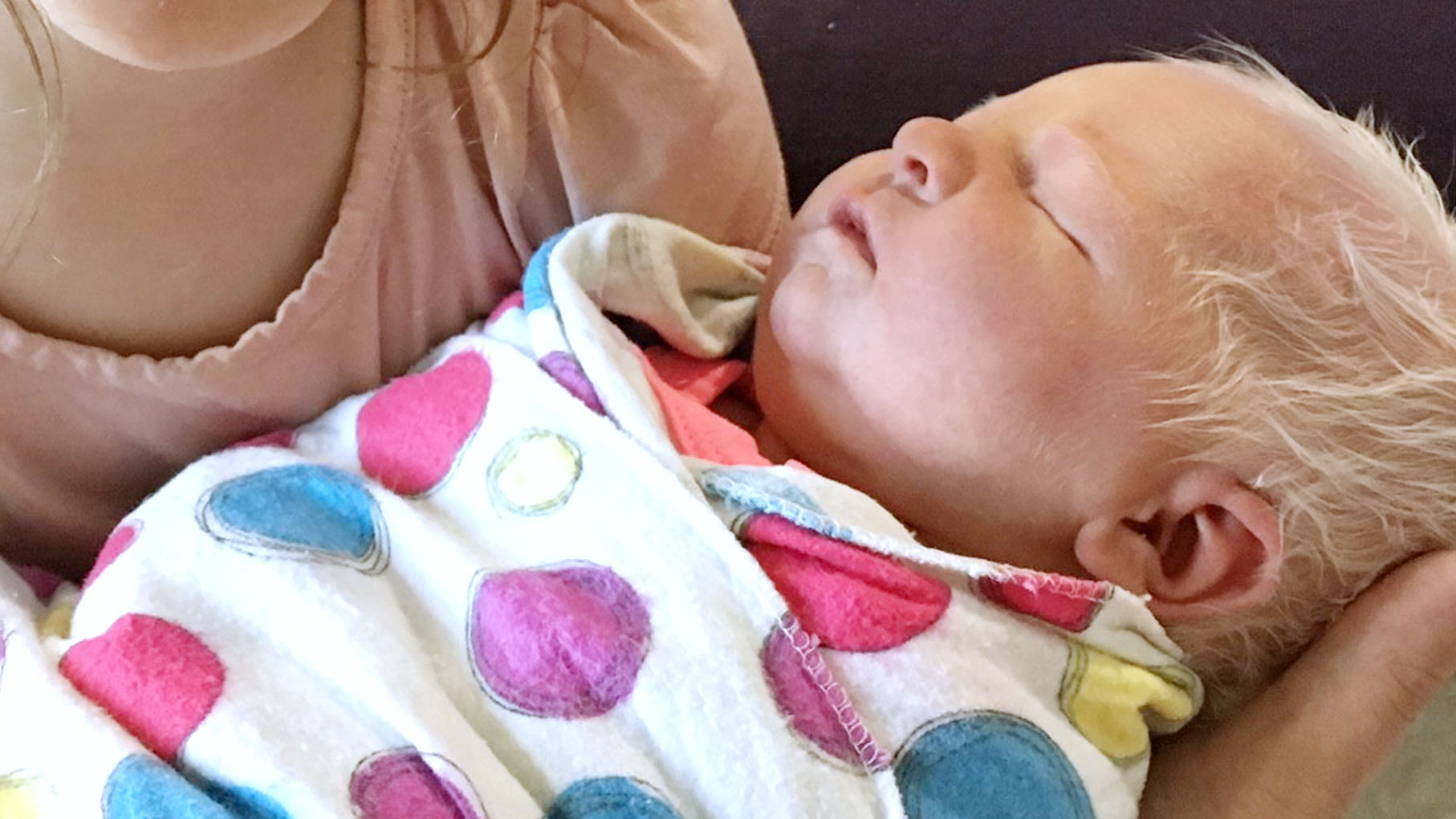 Newborn Hazel sleeping in a blanket