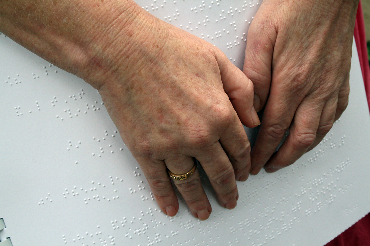 Hands reading braille