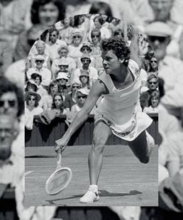 Tennis great, Yvonne Goolagong Cawley, in action on a tennis court, she is lunging forward concentrating on getting to the ball. There isn't an empty seat in the stands - courtside spectators are wearing hats and sunglasses