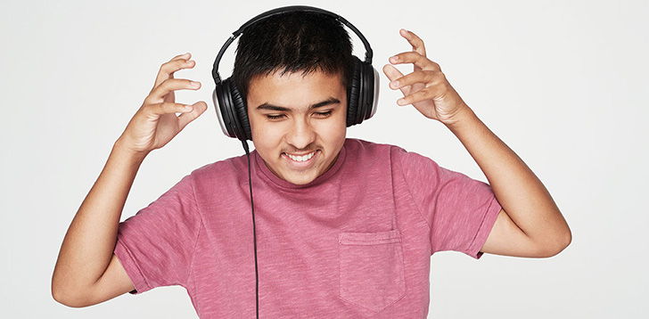 Young man listens to headphones