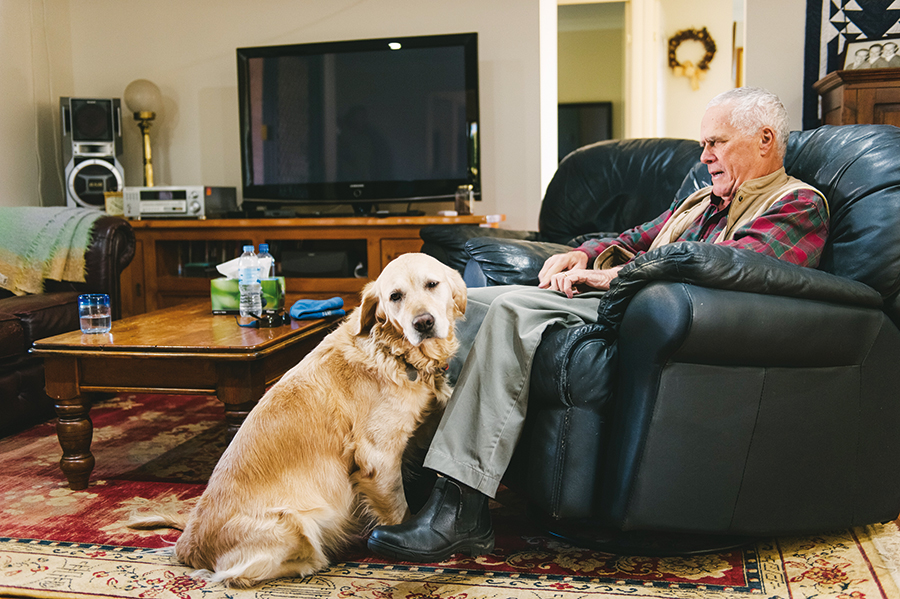 David and Seeing Eye Dog home David sits in his lounge chair at home with Zahra sitting next to the lounge chair