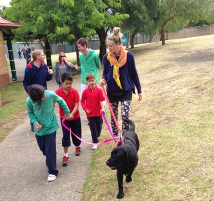 Faith 1 A group of children walk with Faith the labrador