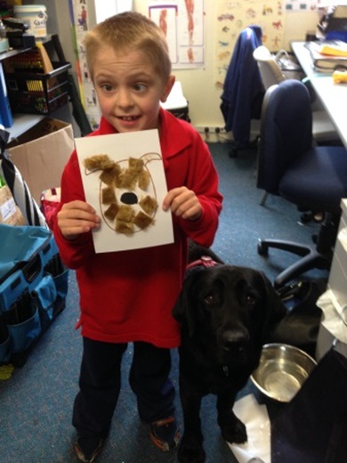 Faith 2 Young student proudly shows us his artwork of Faith the labrador