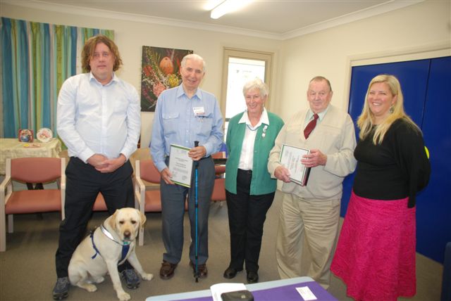 ACT Volunteers Vision Australia volunteer co-ordinator Steven Cuthbert and his seeing eye dog Alfie with Vision Australia volunteers.