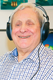 Frank Nowlan smiling with headphones on head Frank Nowlan smiling with headphones on head