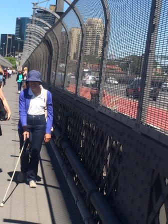 Photo of Gwen Isaac walking across the Sydney Harbour Bridge