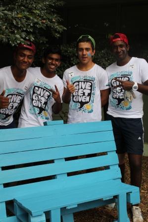 Optus Rockcorps volunteers complete bench group of young volunteers proudly show off the finshed bench