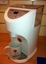 Image of the kettle, with mug underneath the nozzle