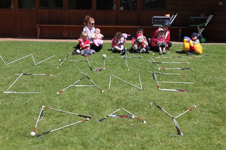 White canes aligned to spell out the words White Cane Day on the slope of a hill with the kids and bears at the top of the hill