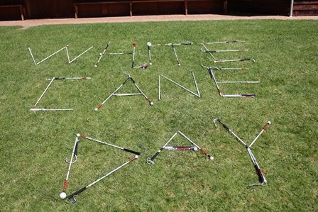 White Canes spelling out the words White Cane Day on grass