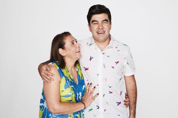 Man and a woman with arms around each other laughing 